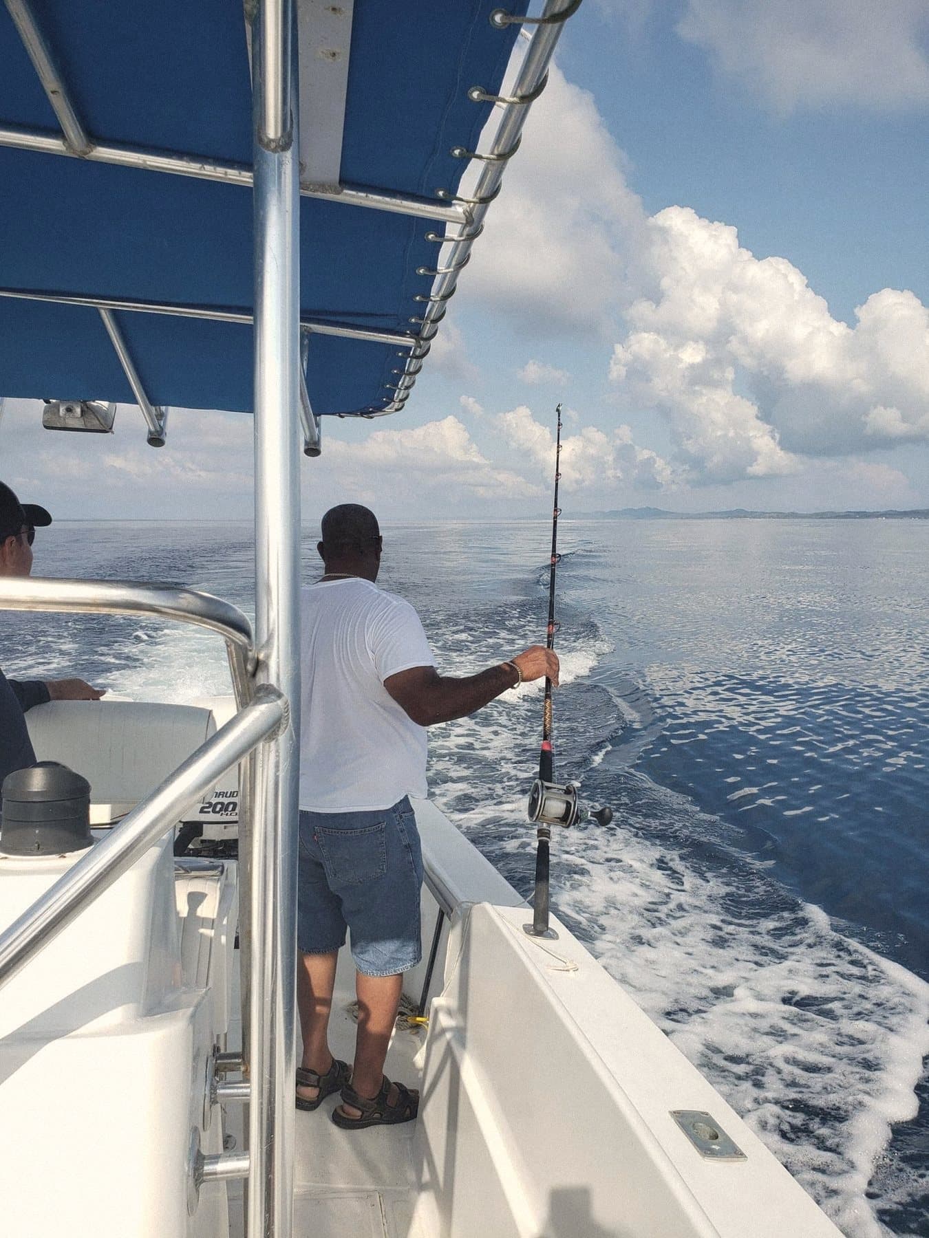 A guest fishing off the back of a charter boat